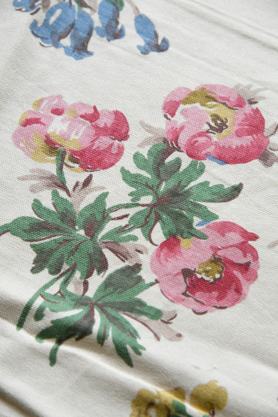 Close crop of floral fabric highlighting bloom details and decorative composition