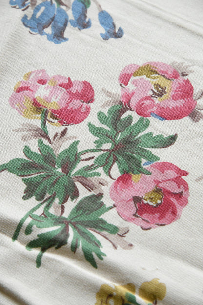 Close crop of floral fabric highlighting bloom details and decorative composition