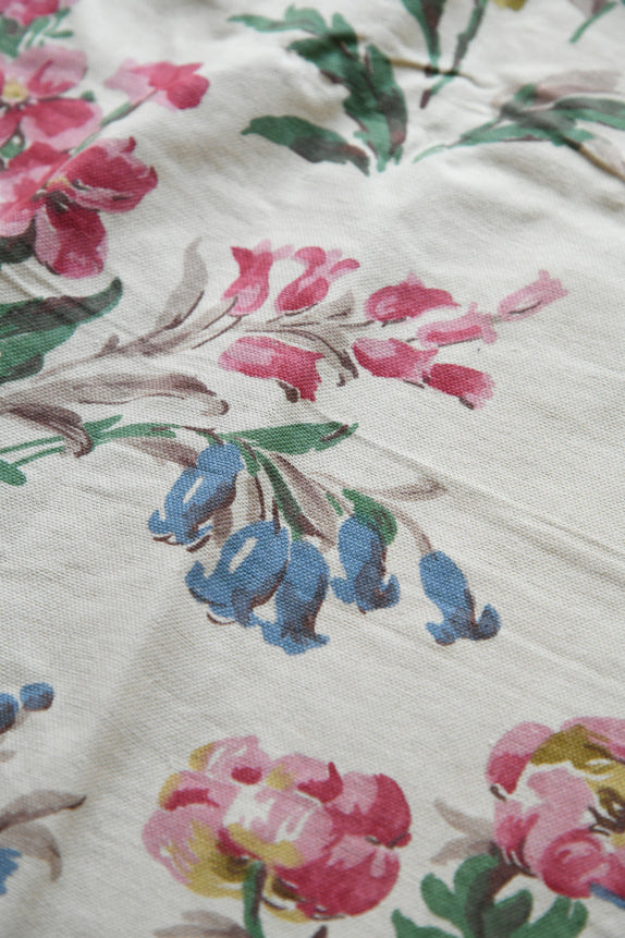 Detail of botanical print pattern showing colour layering and aged textile character